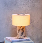 Illuminated cordless table lamp with a sculptural Calacatta Viola marble base, warm fabric shade and distinctive burgundy veining.