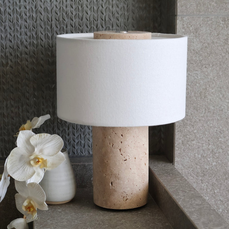 Natural travertine stone lamp base showing organic porous texture