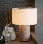Travertine table lamp emitting warm ambient glow