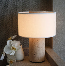Travertine table lamp emitting warm ambient glow