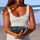 Decorative Verde Alpi marble bowl sculptural centrepiece object held by woman on beach