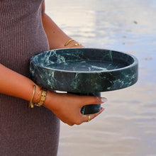 Verde Alpi marble pedestal bowl showing natural green stone veining held by woman