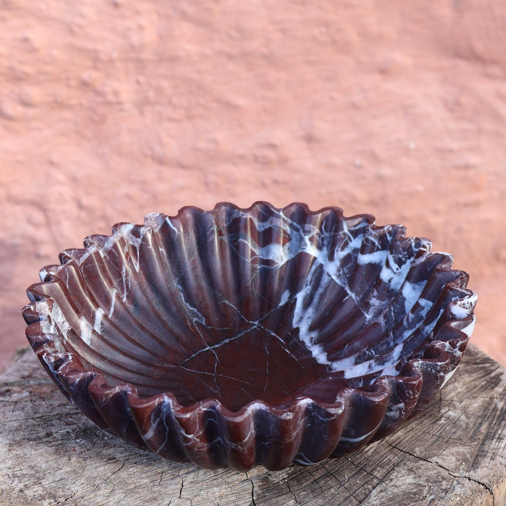 Close up of Rosso Levanto marble bowl showing natural red stone veining