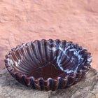 Close up of Rosso Levanto marble bowl showing natural red stone veining