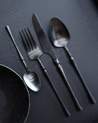 Matte black cutlery set styled on dining table for modern entertaining