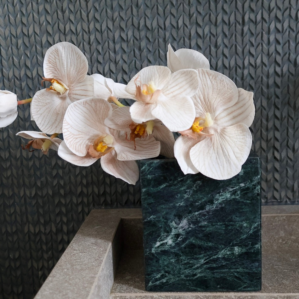 Verde Alpi marble vessel styled on bathroom vanity as marble flower vase