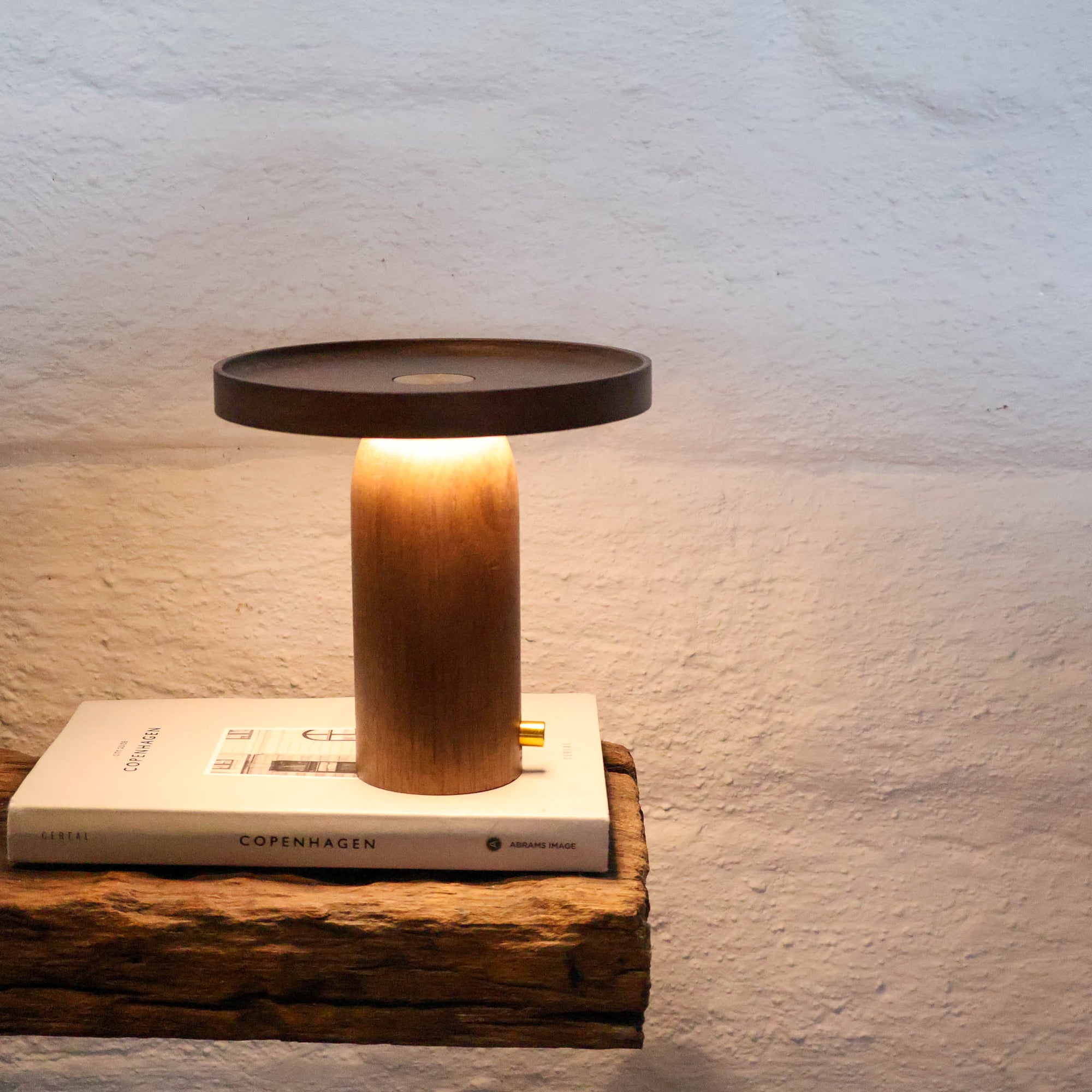 Walnut timber portable table lamp with warm ambient glow by Lokah & Co