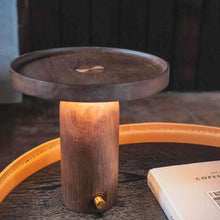Walnut table lamp styled on coffee table with warm soft lighting