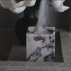 Calacatta Viola marble square vessel used as candle holder using candle sand