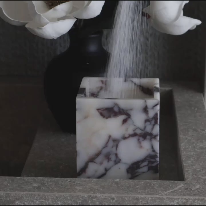 Calacatta Viola marble square vessel used as candle holder using candle sand
