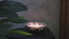 Calacatta Viola marble scalloped bowl sculptural marble bowl emitting ambient candle glow using candle sand